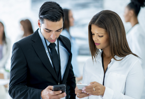 two figures viewing a phone